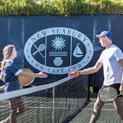 Friends playing tennis at New Seabury