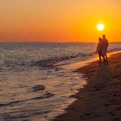 couple on romantic walk on New Seabury beach