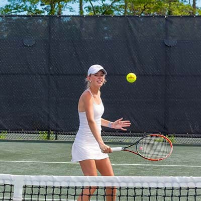 woman playing tennis at New Seabury tennis court